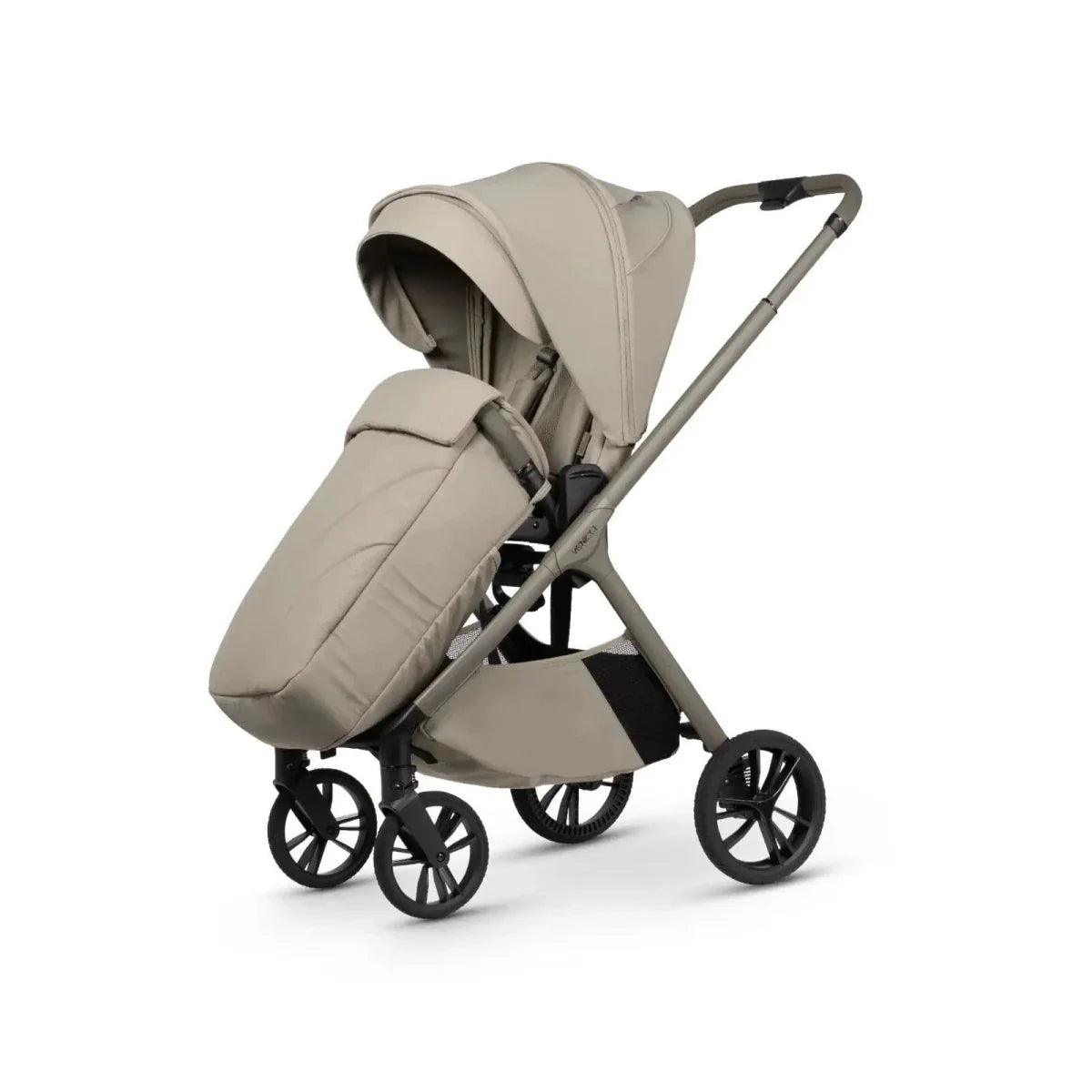 Beige stroller with carrycot and seat unit, front canopy view, black wheelbase