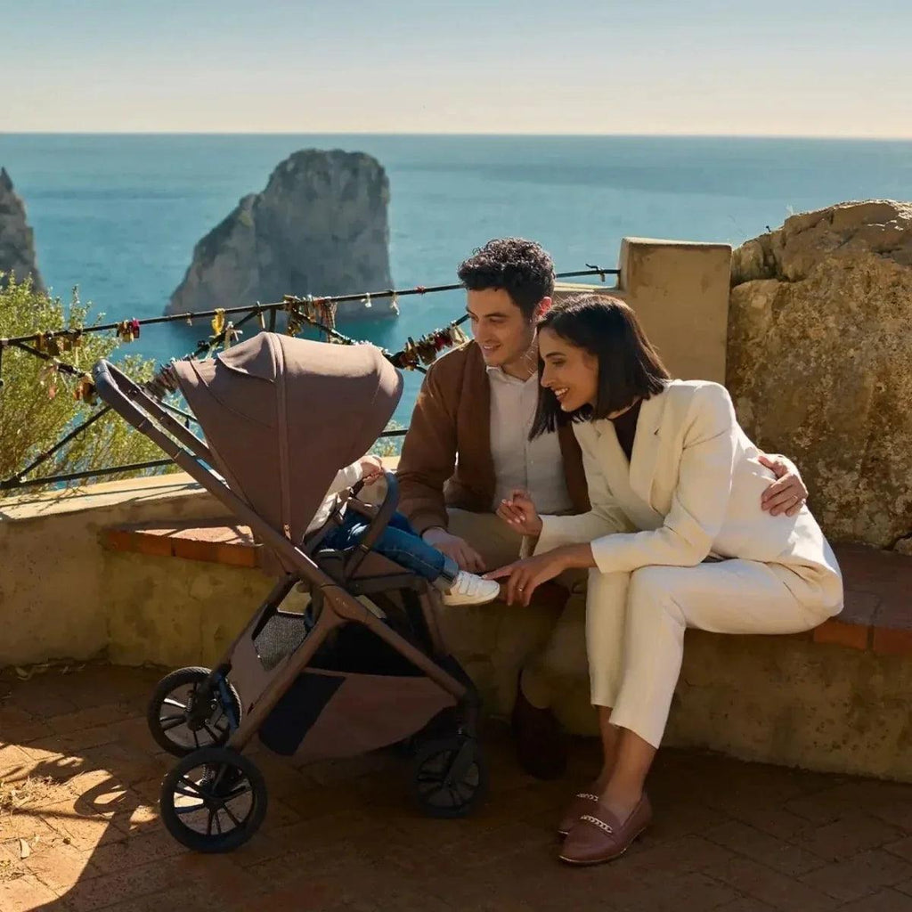 Brown stroller with large wheels and attached seat, 2-in-1 style