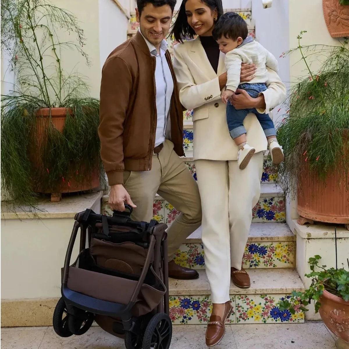 Brown stroller pushchair with handlebar and footrest, full view
