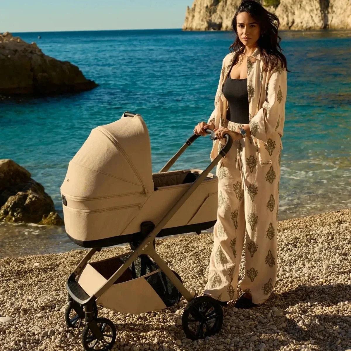 Light beige stroller with canopy and black wheels, shown outdoors