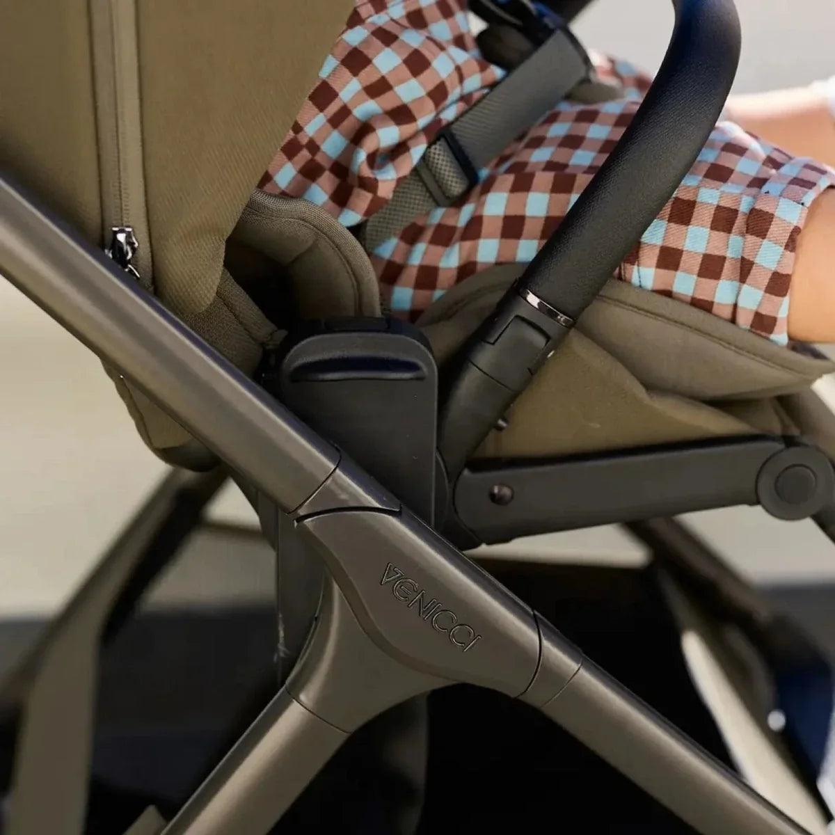 Beige stroller with padded seat and blue check-pattern insert, black handle