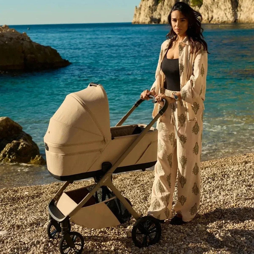 Beige travel stroller with canopy and padded seat cover