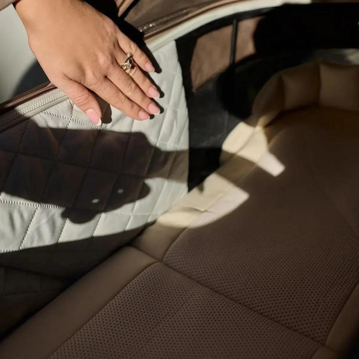 Stroller seat interior with quilted brown upholstery and perforated backrest