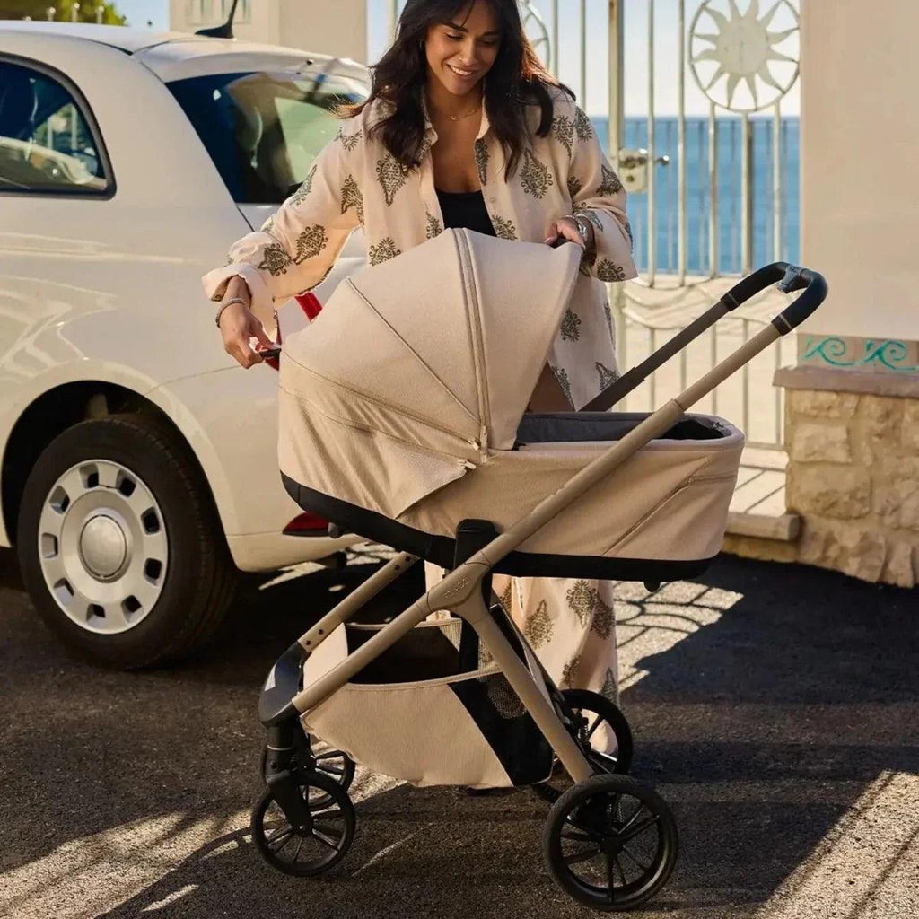 Beige 3-in-1 stroller with carrycot, canopy, and two front wheels