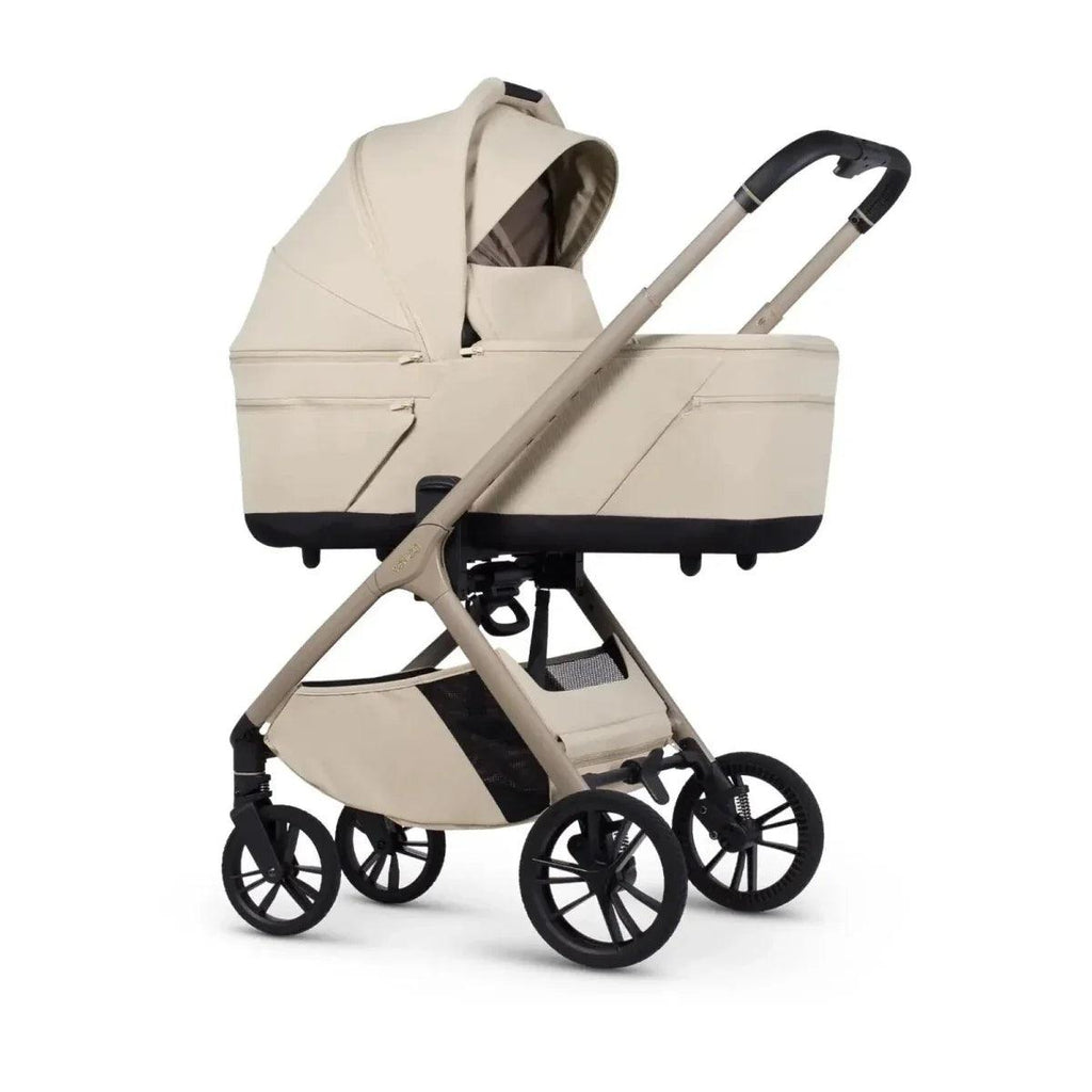 Beige stroller with bassinet and frame, black wheels and handlebar