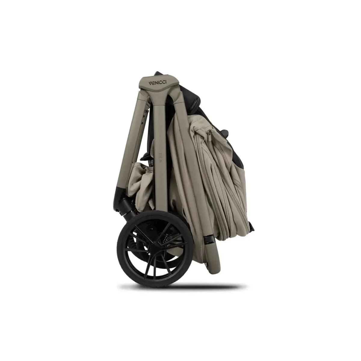 Latte stroller with carrycot and folded canopy, side view with black wheels