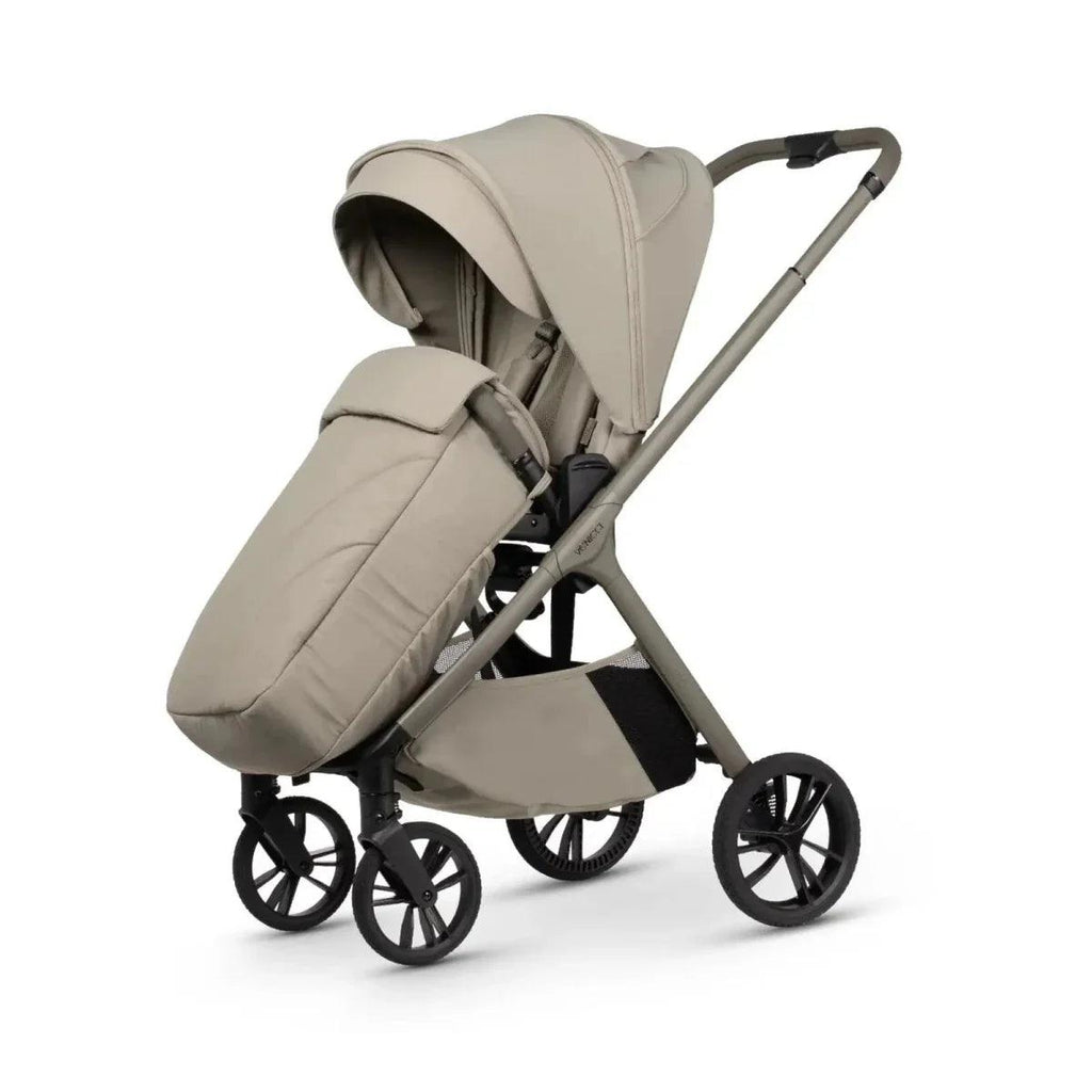 Latte stroller with extended canopy and front wheel detail, angled side view