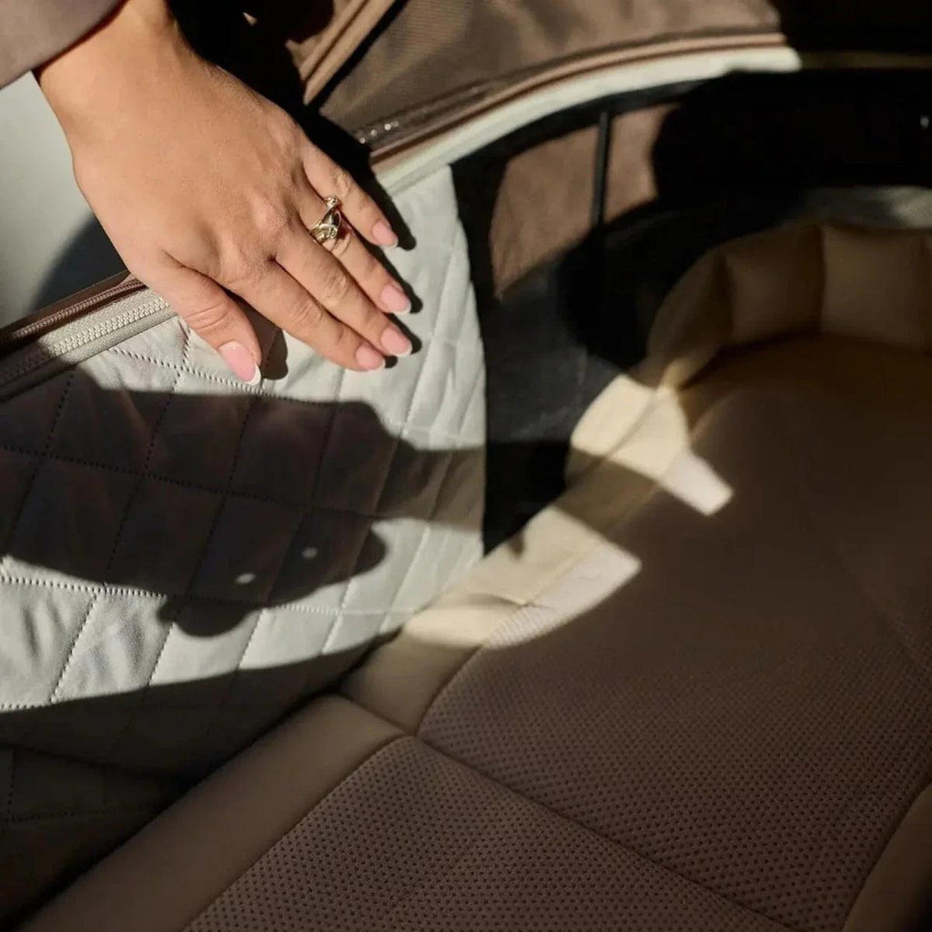 Dark taupe stroller seat cover with stitched panels and zipper detail