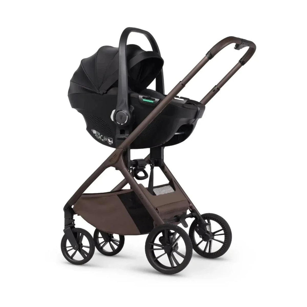 Black stroller frame with attached infant car seat and canopy