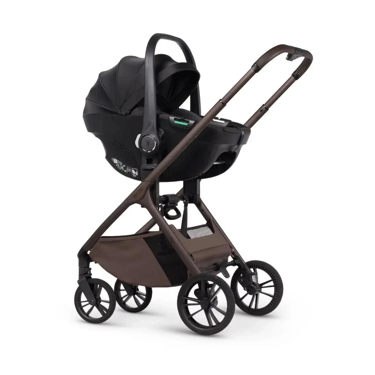 Black stroller frame with attached infant car seat and canopy