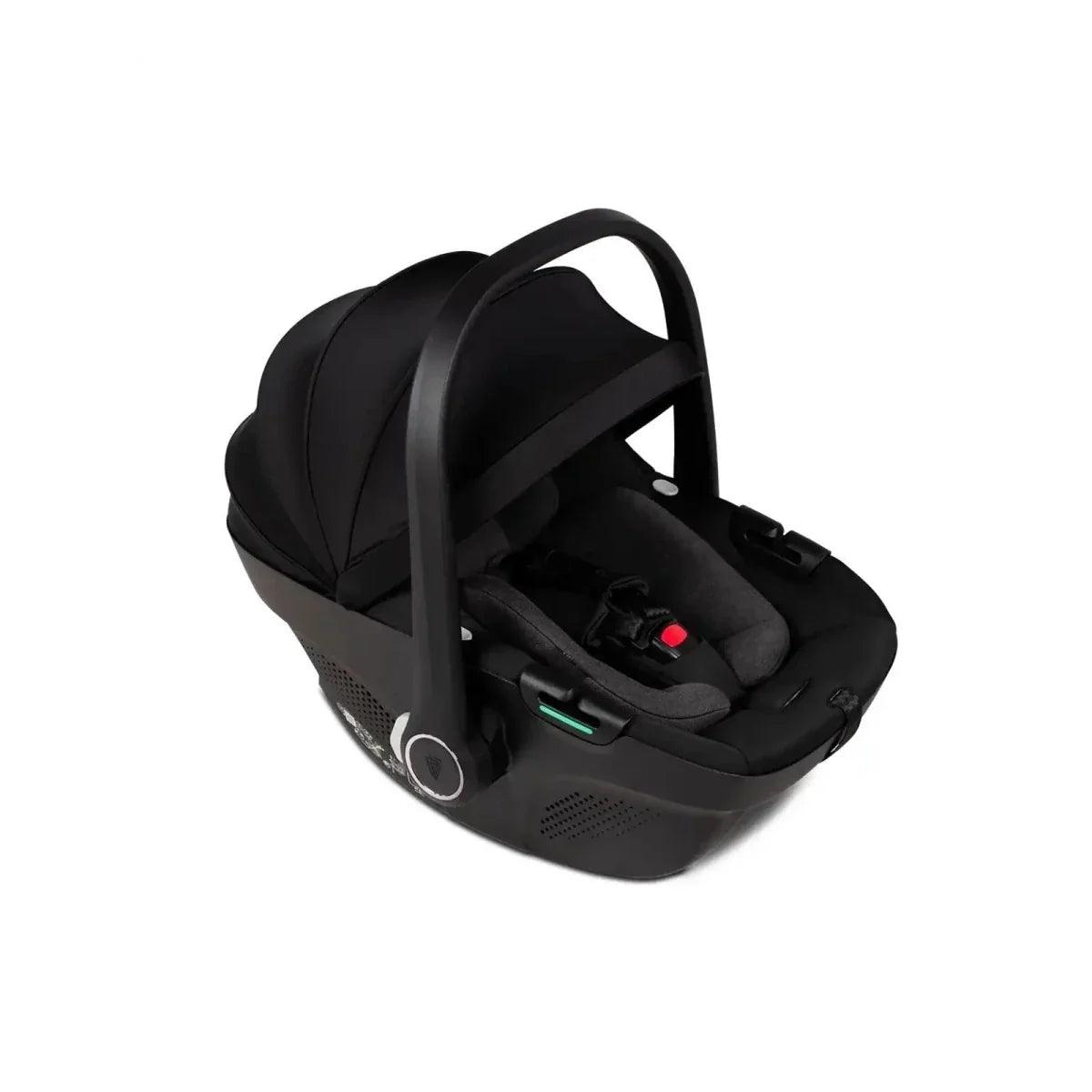 Black infant car seat with handle and harness, angled close-up