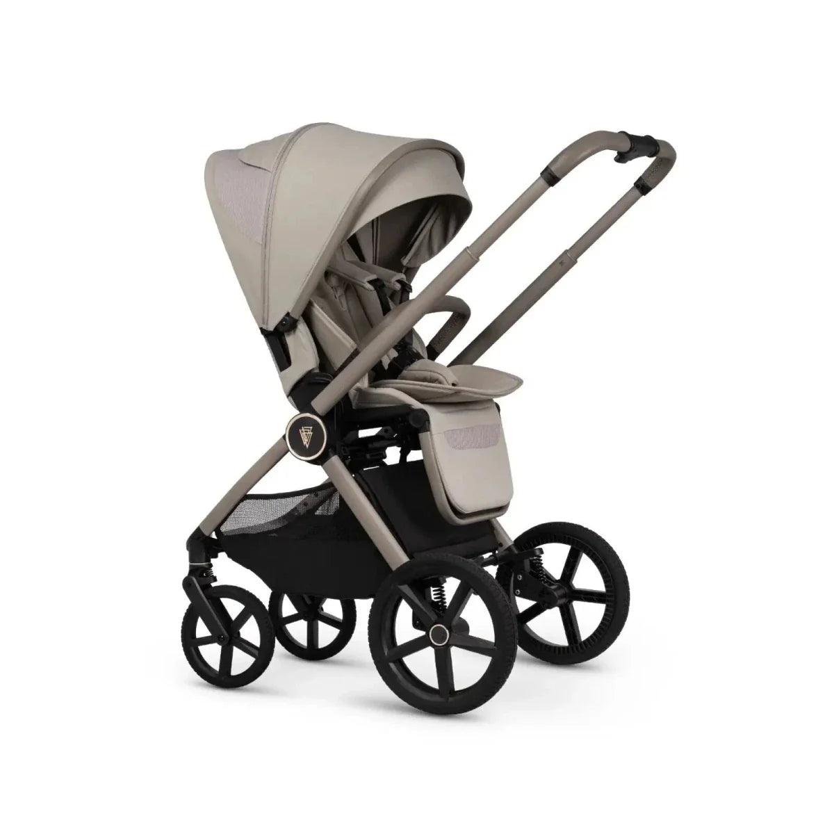 Pebble baby stroller with beige seat and canopy, black frame, front three-quarter view