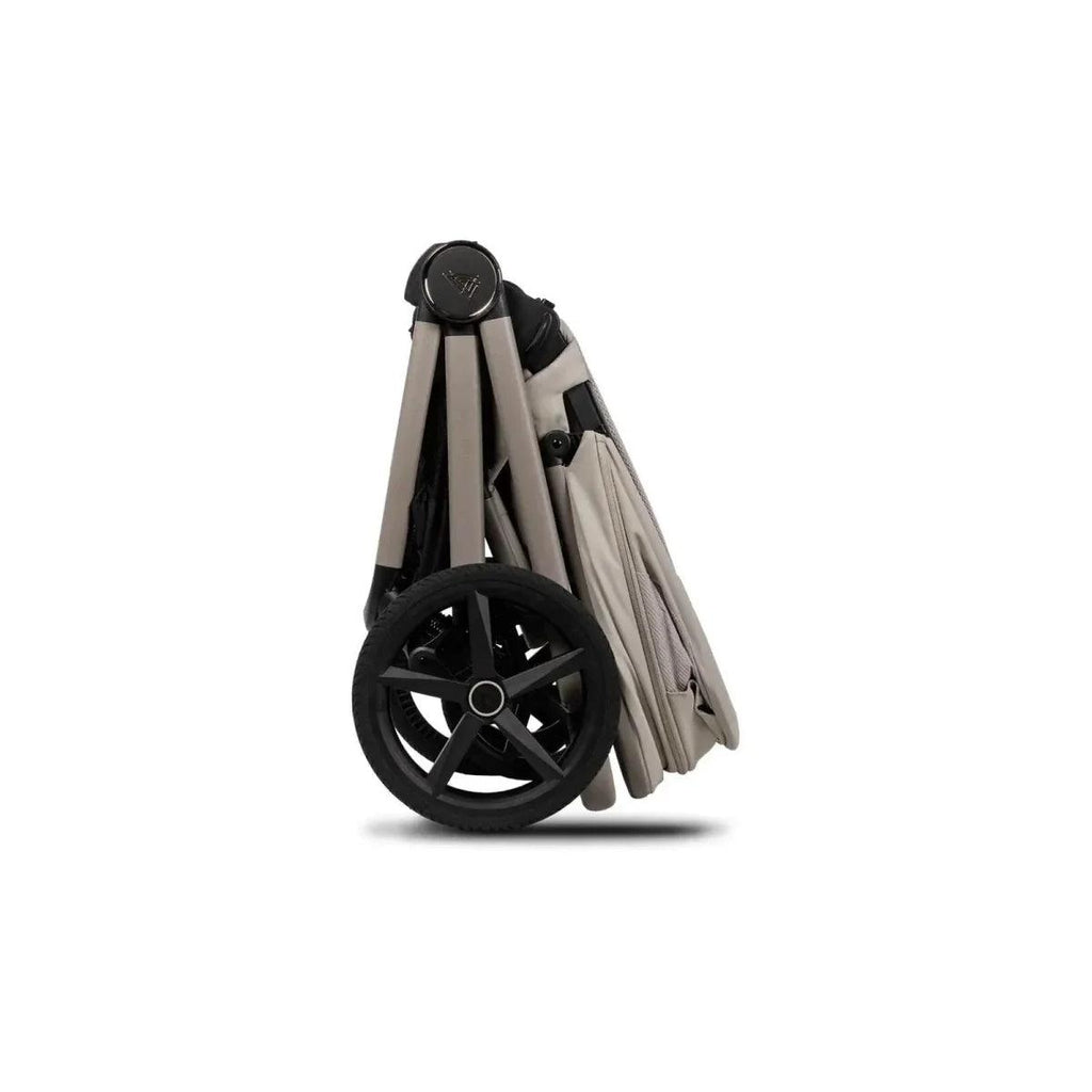 Pebble stroller with beige carrycot, black wheelbase, and folded frame, side view