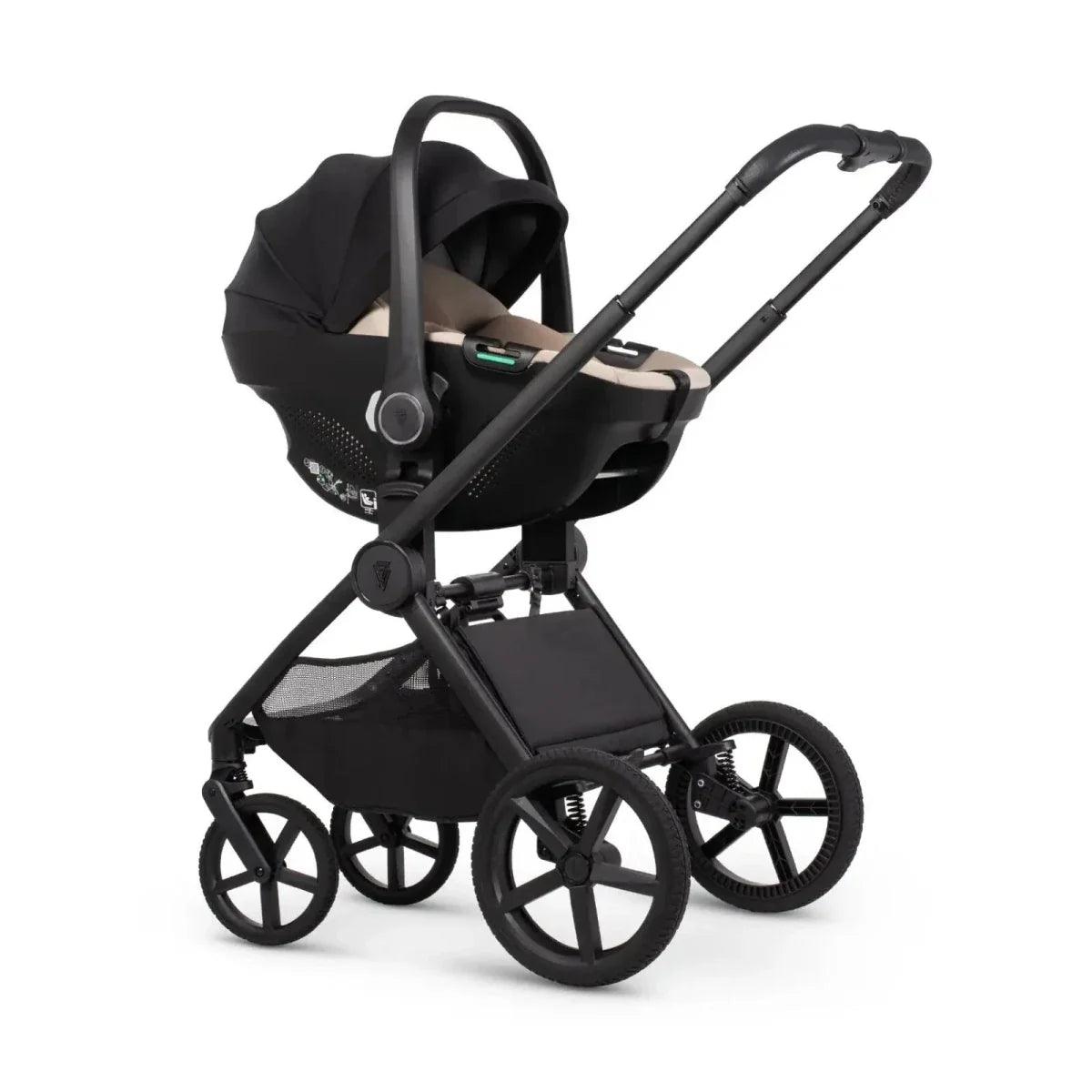 Black infant car seat mounted on stroller with canopy