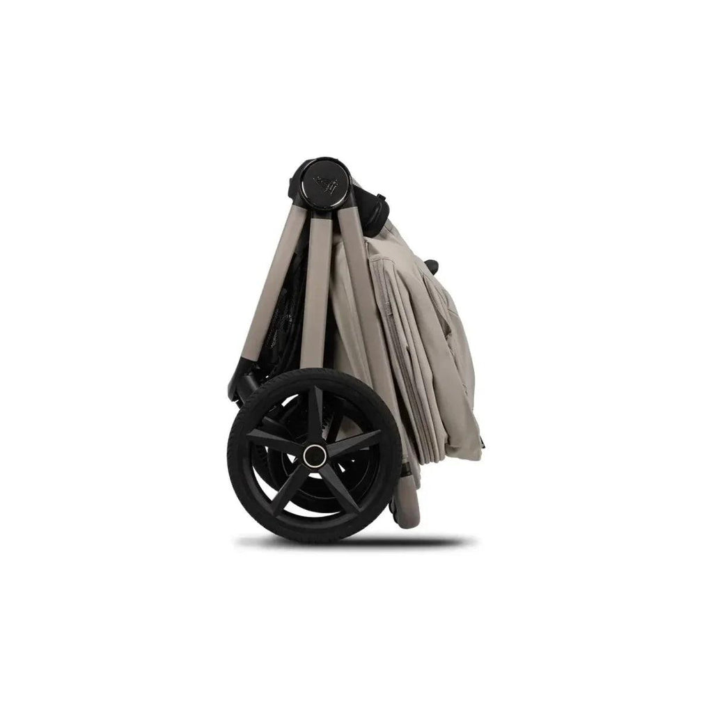 Stroller with pebble fabric carrycot and black wheels, side view