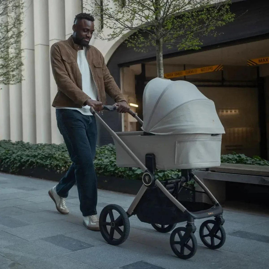 Cream stroller bassinet with canopy and front swivel wheels