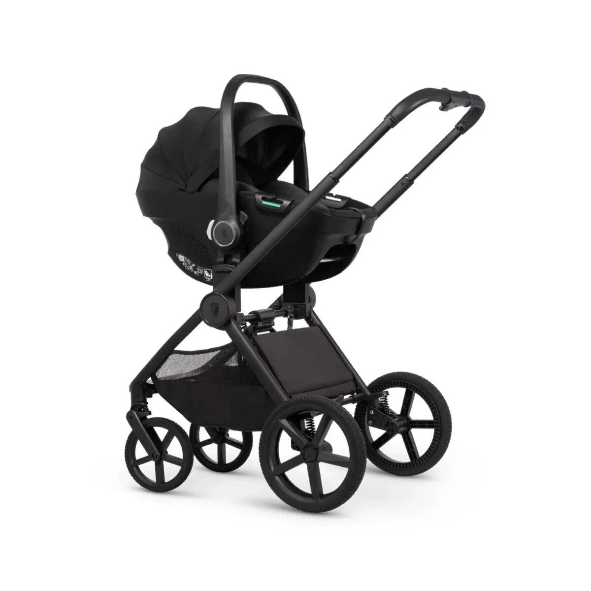 Black stroller with carrycot, canopy handle, and seat unit on a multi-wheel frame