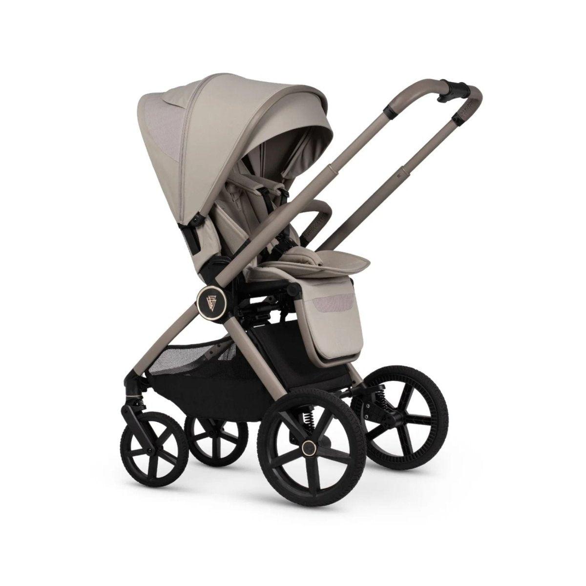 Beige stroller with canopy, padded seat, and black wheels on light frame