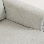 Light grey recliner armrest with curved padding and small metal rivets.