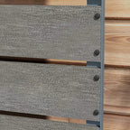 Close-up of dark grey planter box panel with corner screws and visible textured surface