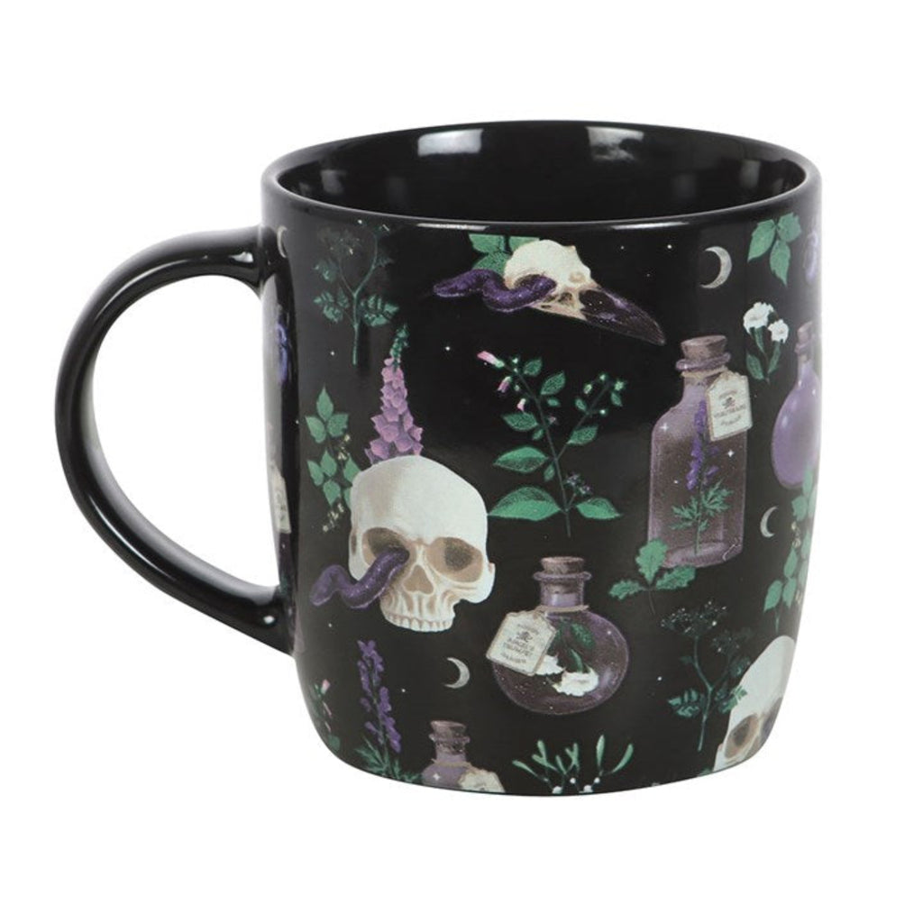 Black mug with design featuring skulls, bottles, and plants on a white background