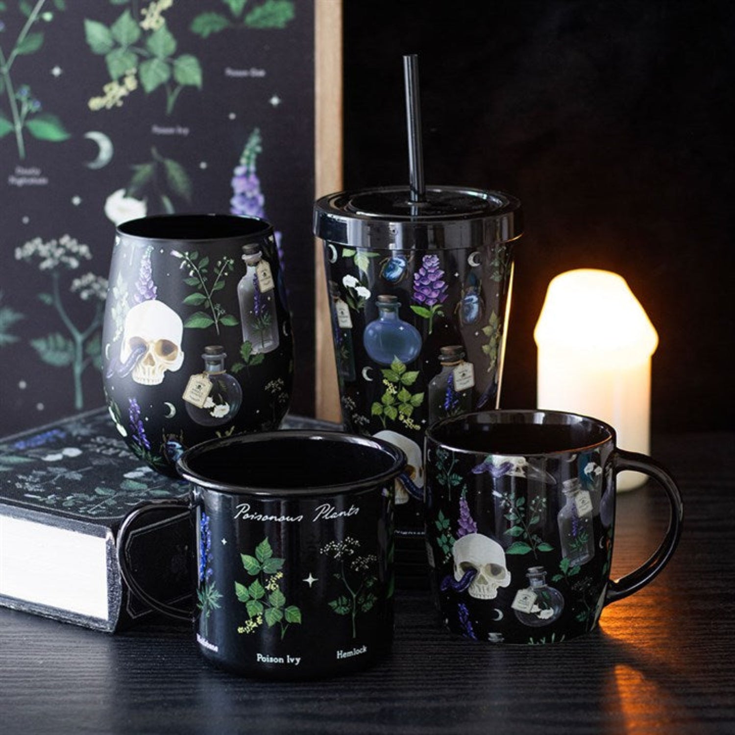 Set of black mugs with botanical and skull designs on a dark surface.