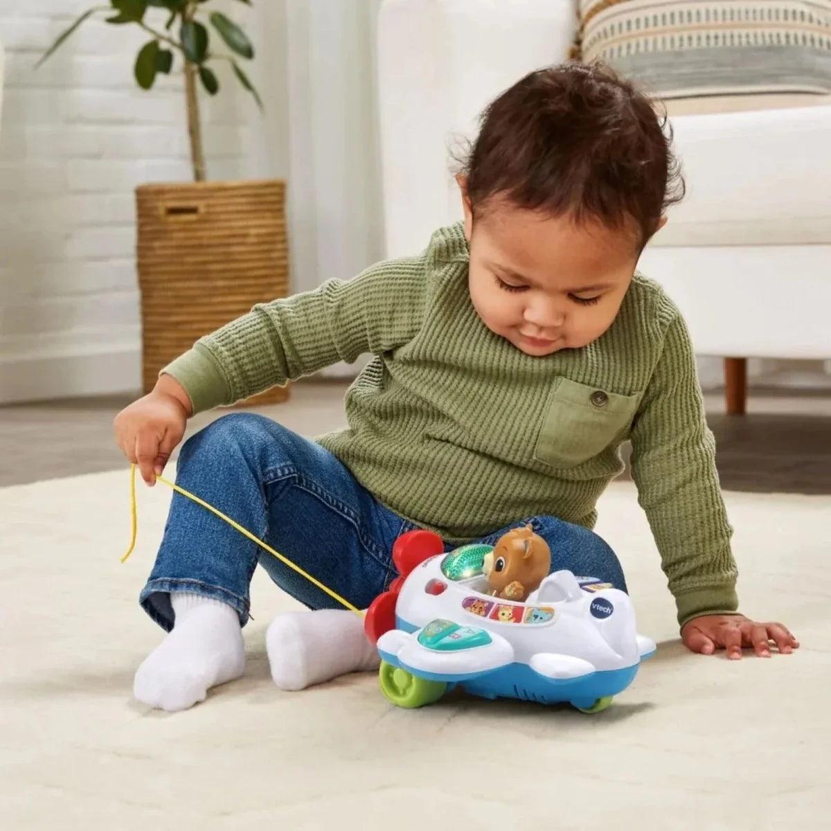 Infant tugging VTech baby aeroplane pull toy with yellow string