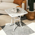 White cast aluminium patio end table with lattice top, central umbrella hole, curved legs