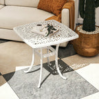 White cast aluminium patio end table with lattice top, central umbrella hole, curved legs