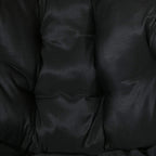 Close-up of black upholstered cushion with quilted, padded stitching