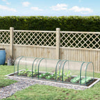 Clear mini greenhouse polytunnel with steel frame, installed over garden bed