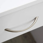 White desk drawer with curved metal handle.
