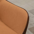 Light brown velvet armrest and seat edge with dark trim piping