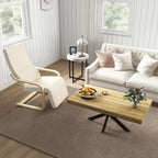 Cream upholstered lounge chair with light wood base in a bright room by windows