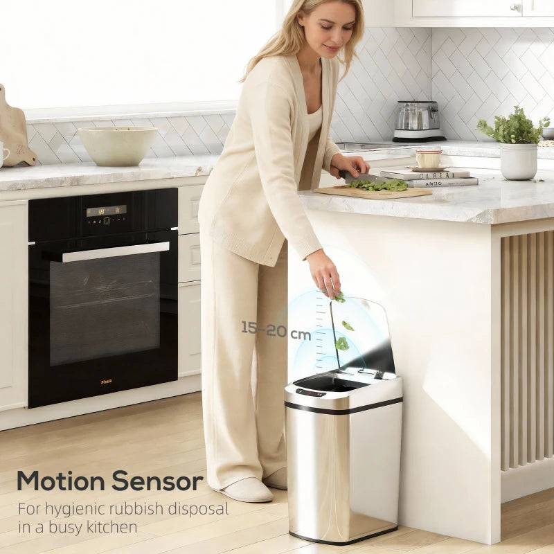 Silver stainless steel touchless sensor trash bin with open lid near kitchen counter