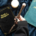 Rose quartz wand held in hand, copper spiral handle with round pink stone top