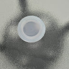Close-up of umbrella hole insert on black bistro table with clear plastic ring