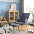 Dark grey wingback accent chair with ottoman in living room setting, gold-tone legs