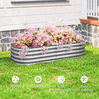 Gray galvanized metal raised garden bed with pink flowers on a lawn