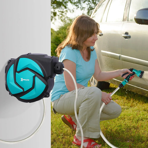 Wall-mounted retractable hose reel with spray nozzle and gray coiled hose