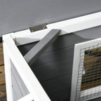 Grey wooden dog kennel roof panel with metal hinges and latch near the entrance