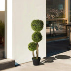 Artificial boxwood ball topiary tree set in black pot, three green spheres on display