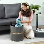 Grey ribbed storage ottoman with open top as a person places a folded blanket inside
