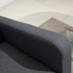 Charcoal grey upholstered armrest edge with padded cushion