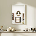 White framed rectangular wall mirror reflecting decor and a chessboard