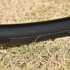 Close-up of black metal base tube on a rocking chaise lounge, textured finish