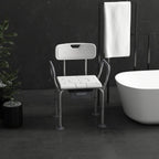 White shower stool with arms and backrest, padded seat with commode bucket opening