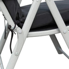 Close-up of black cushion and tie strap on white steel lounge frame