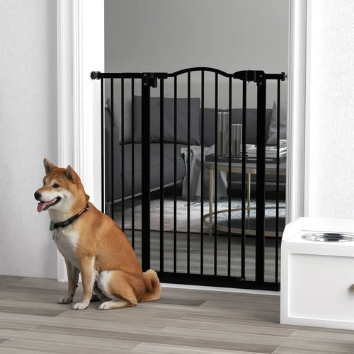 Black pressure-fit dog safety gate with vertical bars and a dog sitting outside
