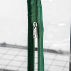 Zippered door seam detail on green mini greenhouse cover, clear plastic